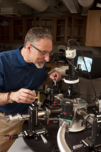 Howard Katz adjusting probes used for testing electronic devices. Photo: Will Kirk, homewoodphoto.jhu.edu