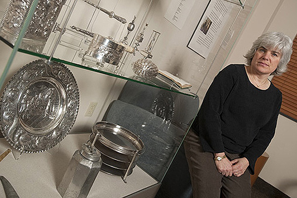 Dozens of Jewish ceremonial pieces, most of them silver, had been dispersed in Baltimore and were recently returned to Johns Hopkins, where they are housed in the Smokler Center for Jewish Life. At right, Hillel director Rabbi Debbie Pine. Photo: Will Kirk/Homewoodphoto.jhu.edu